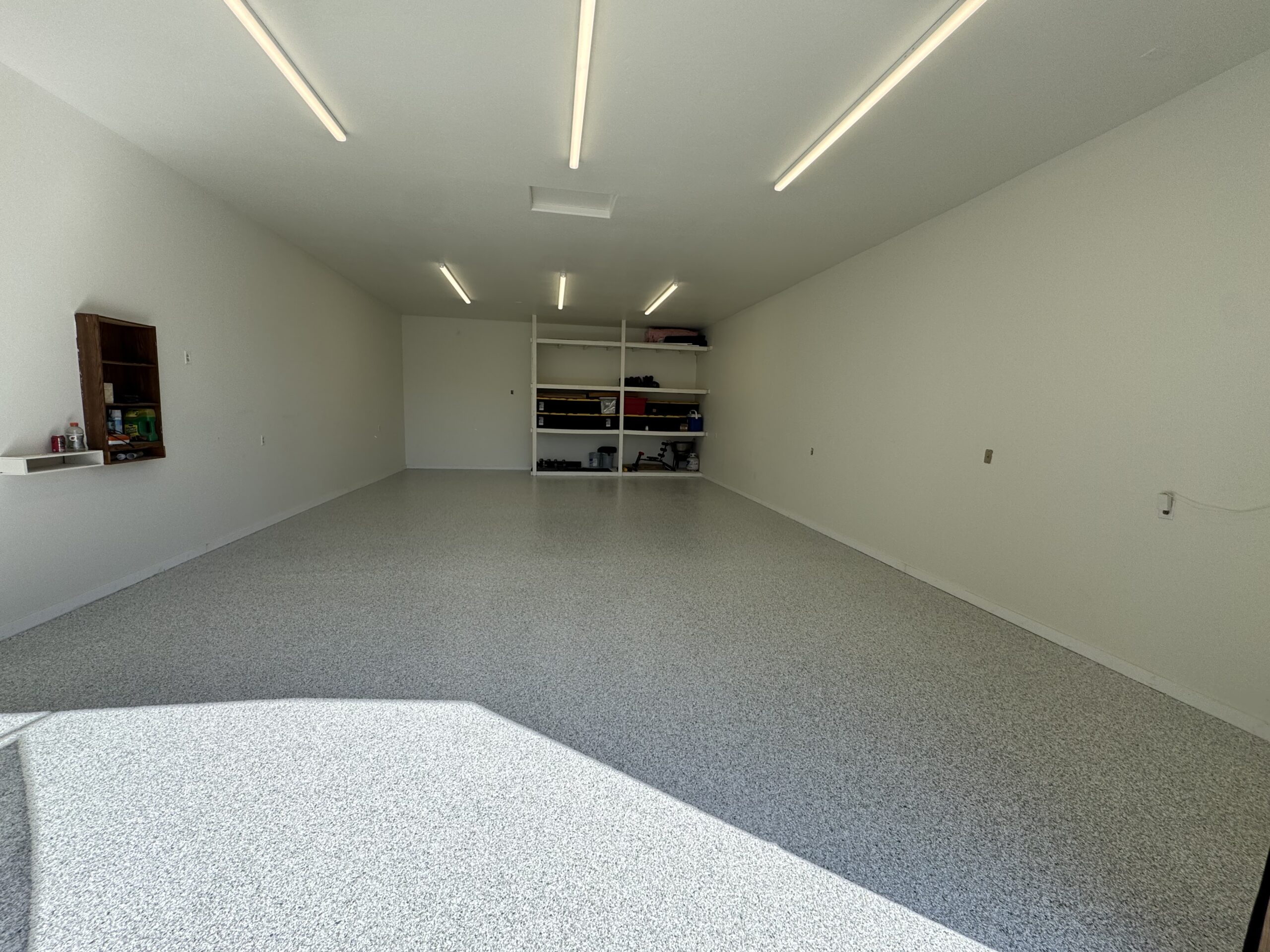 Finished flake floor system in a residential garage