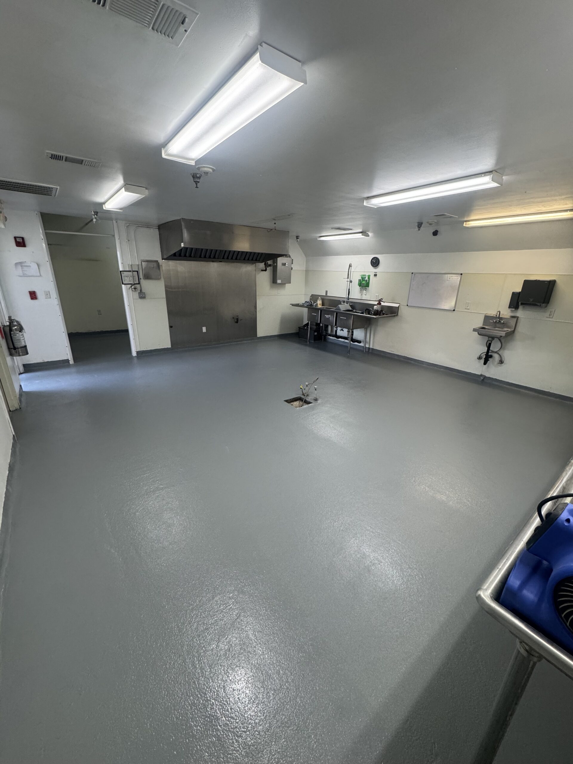 Protective floor coating applied in a commercial kitchen workspace